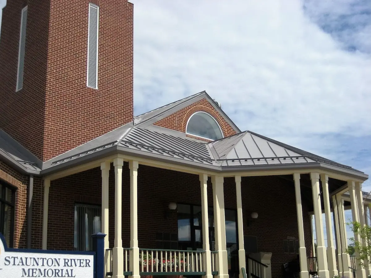 Skilled roofing craftsmen working on a residential roof in Downtown Dedham